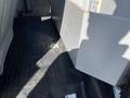 Interior view of a 2013 Ford F-250 SD showing vinyl flooring and a partial console or storage compartment with light and shadow effects