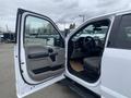 A 2019 Ford F-150 with an open driver side door revealing the interior including the dashboard and seating area