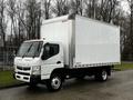 A 2021 Mitsubishi FE box truck with a white exterior and a large cargo area on the back