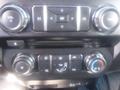 Close-up of the control panel in a 2018 Ford F-350 SD featuring knobs for temperature and fan settings as well as buttons for volume and navigation functions