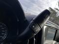 Close-up of the steering wheel and control lever of a 2017 GMC Sierra 3500HD featuring buttons for gear shifting and vehicle functions