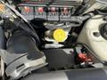Close-up of the engine compartment of a 2005 Chrysler PT Cruiser showing various components including wires hoses and a yellow cap