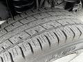 A close-up image of a tire from a 2008 Ford Econoline showcasing its tread pattern and surface details