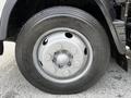 A close-up view of the wheel of a 2015 Mitsubishi Fuso FE featuring a gray rim and a Toyo tire with visible tread markings
