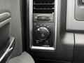 Close-up view of a 2018 RAM 1500 dashboard control panel featuring knobs and buttons for air vents light settings and other vehicle functions