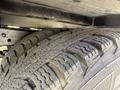 A close-up of a worn tire from a 2016 Ford Transit showcasing treads and grooves designed for traction and stability