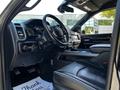 Interior view of a 2022 RAM 3500 with a steering wheel dashboard and leather seats visible