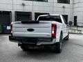 A white 2017 Ford F-250 truck seen from the rear with the Super Duty logo visible on the tailgate and dual exhaust pipes at the back