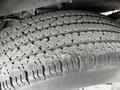 A close-up view of a worn tire tread on a 2023 GMC Savana showing detailed patterns and grooves
