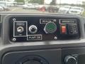 Control panel of a 2010 Ford Econoline featuring buttons and switches for beacon, pump, and versalift power with labeled indicators