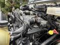 Close-up of a 2016 International CE300 engine showing various components including hoses wires and a reservoir with a yellow cap