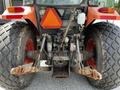 Rear view of a 2011 Kubota M8540D tractor showcasing the large rear tires and hydraulic connectors attached to the rear frame