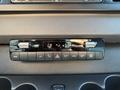 Control panel of a 2023 Mercedes-Benz Sprinter featuring climate control knobs digital display and various function buttons