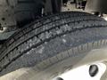 Close-up of a heavily worn tire on a 2007 GMC W3500 showing visible tread wear and dirt accumulation on the rubber surface
