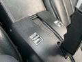 Close-up of the center console in a 1972 Chevrolet Corvette featuring silver controls and textured black upholstery