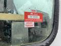 A close-up of a wet window displaying a red certificate of approval sticker with the text 2026 GH 26365 and the months January and February