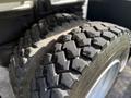 Close-up of two large, rugged tires with deep treads designed for durability and traction on a 2015 Peterbilt 337 truck