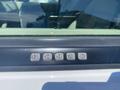 A keypad on the driver's side door of a 2013 Ford Expedition with numbers 1 through 9 arranged in two rows