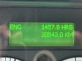 Digital display showing engine hours 1457.8 and distance 30543.0 kilometers on a Freightliner 108SD