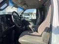Interior view of a 2016 GMC Savana showing the driver's seat steering wheel and dashboard with a gray fabric design