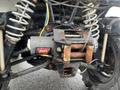 Close-up of a 2017 Polaris Scrambler's front suspension and winch showing metal components and wiring with visible rust on some parts