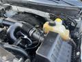 A close-up view of the engine bay of a 2014 Ford F-150 showcasing the air intake system and coolant reservoir