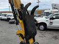 A 2024 Caterpillar 306 excavator attachment featuring a large grapple bucket designed for lifting and moving materials