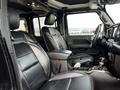 Interior of a 2019 Jeep Wrangler featuring black leather seats with a center console and dashboard controls