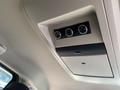 Interior ceiling of a 2020 Dodge Grand Caravan featuring climate control knobs and a panel for overhead storage