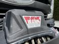 Close-up of a WARN winch mounted on the front of a 2017 Ford F-250 SD with a weathered red and white logo