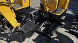 A 2021 Cael-1T Mini excavator with a black hydraulic attachment is shown in detail showcasing its yellow body and tracks