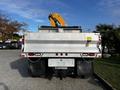 A 2013 International DuraStar 4300 dump truck with a metal bed and visible rear lights parked in a lot