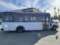 A white 2017 Chevrolet Express bus with large windows and a side entrance, featuring a spacious interior designed for passenger transport