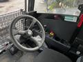 Interior view of the cabin of a 2023 Prinoth Panther T6 featuring a steering wheel and control panel with various levers and buttons