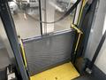 A 2018 Chevrolet Express with a wheelchair lift in the open position showcasing its metal mesh barrier and yellow platform