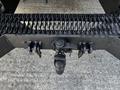 A close-up view of the hitch and towing hardware of a 2008 Ford F-550 showing chains and a ball mount