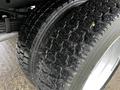 Close-up of the tread on two large tires of a 2017 Ford F-550 showcasing the detailed texture and pattern of the tire surface