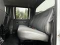 Interior view of a 2005 GMC C5 Duramax showing a gray bench seat with seatbelt in the foreground