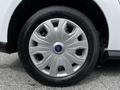 A close-up view of a silver wheel cover on a 2019 Ford Transit Connect tire showcasing a multi-spoke design and the Ford logo in the center