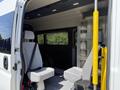 Interior of a 2021 RAM Promaster featuring two gray seats and a storage unit next to them