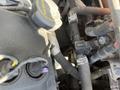 Close-up of the engine components of a 2016 Ford Transit showing various hoses connectors and a black cap labeled with engine specifications