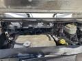 A 2019 Freightliner MT45 engine compartment displaying a rectangular coolant reservoir and various engine components with visible hoses and wires
