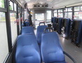 Interior of a 2020 Chevrolet Express with blue seats arranged in rows and a spacious cabin layout