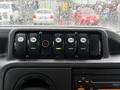 Dashboard controls featuring six buttons for door dome heat and left and right read functions in a 2014 Ford E-450