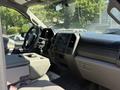Interior view of a 2017 Ford F-350 Super Duty showing the dashboard steering wheel and front seats with control panel and storage compartment