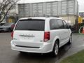 A white 2017 Dodge Grand Caravan parked with a blank rear license plate visible and a simple tailgate design