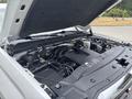 A 2016 GMC Sierra 1500 engine view showing components like the air intake system and various engine parts clearly visible under the raised hood