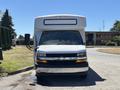 A white 2020 Chevrolet Express van with a large front hood and prominent headlights parked on a paved surface