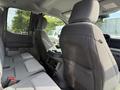 Interior view of a 2023 Ford F-550 showcasing the rear seats and center console with gray upholstery