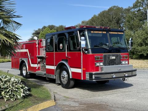 A red 1992 Emergency One Typhoon Superior fire truck with chrome accents and "We Support Our Canadian Forces" written on the front